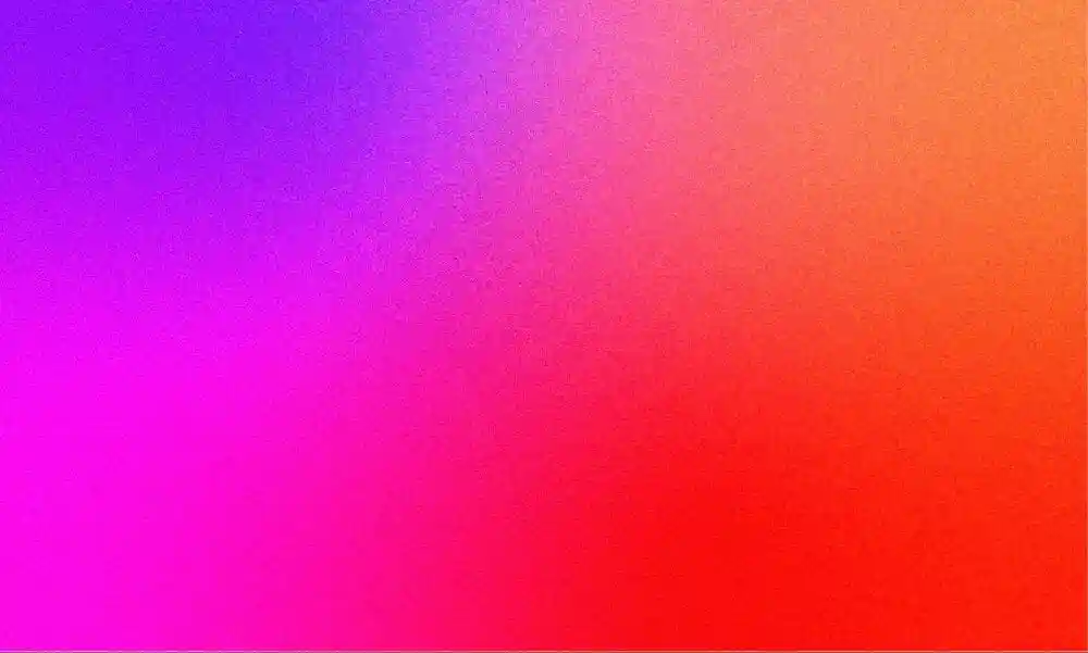 A grainy gradient made of purple, pink, orange, and red.